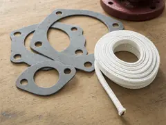 Asbestos sheet gasket and braided valve packing on a pump flange